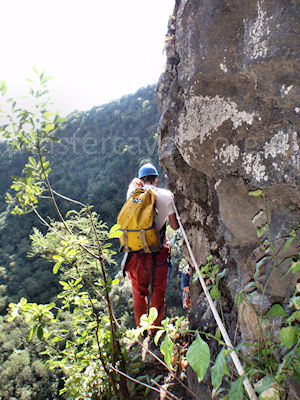 A canyoneer on the exposed traverse from the Grotte de la Grande Ravine, Ile de la Reunion, September 2009